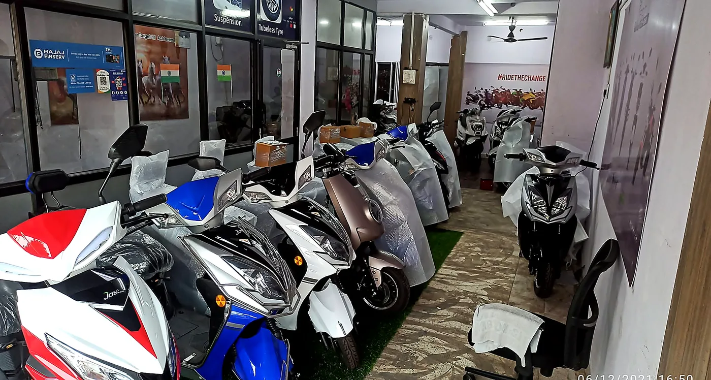 Rows of new electric scooters lined up inside the Hindustan E-Bike showroom floor
